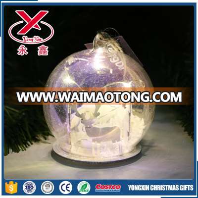 Clear Christmas glass led lighted ball with wood chip in it